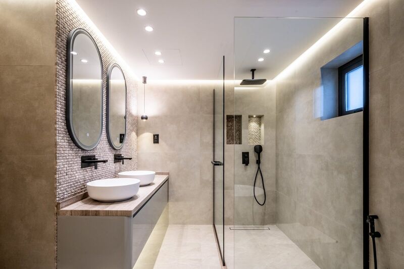 Renovated bathroom with large-format stone tiles and modern fixtures — The Meadows villa